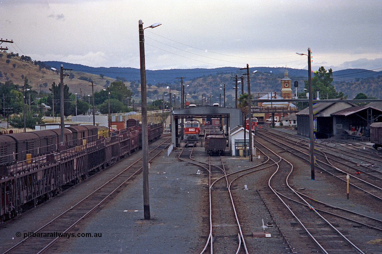 100-02
Albury station yard overview looking south, from Wilson Street footbridge, loco service shed, NSWSRA standard gauge 81 class 8163 Clyde Engineering EMD model JT26C-2SS serial 84-1082 in candy livery, point and track work, motorail waggons at left, station building with clock tower and goods sheds at right. [url=https://goo.gl/maps/nngpTA37VQekQpCt7]Geodata[/url].
Keywords: 81-class;8163;Clyde-Engineering-Kelso-NSW;EMD;JT26C-2SS;84-1082;