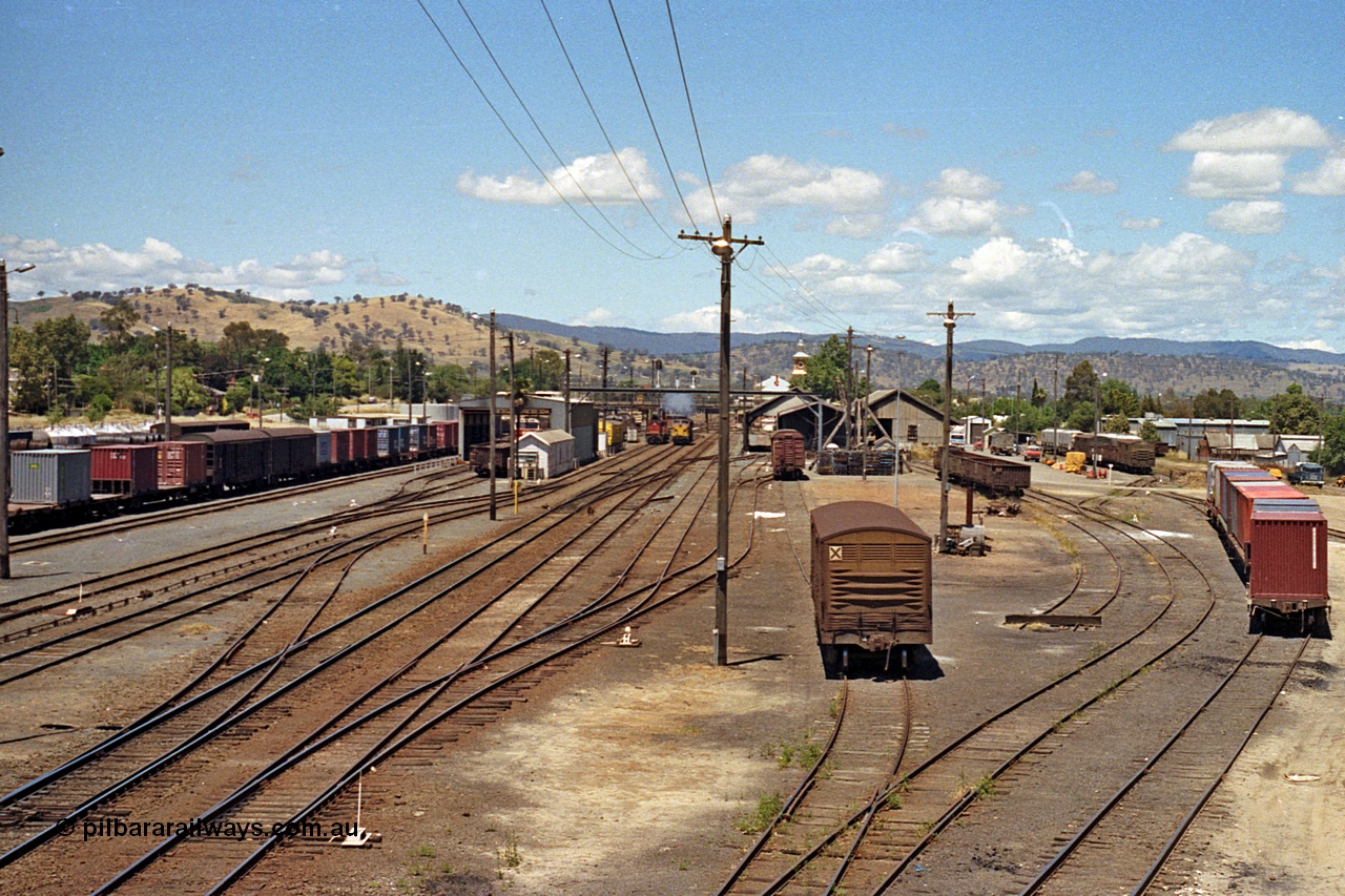 100-12
Albury station yard overview looking south from Wilson Street footbridge, NSWSRA standard gauge 44 class AE Goodwin ALCo model DL500B smokes up in the distance, tracks at right are, standard gauge with louvre vans leading down to goods shed, baulked dead end siding and siding with container waggons are broad gauge. [url=https://goo.gl/maps/nngpTA37VQekQpCt7]Geodata[/url].
Keywords: 44-class;AE-Goodwin;ALCo;DL500B;