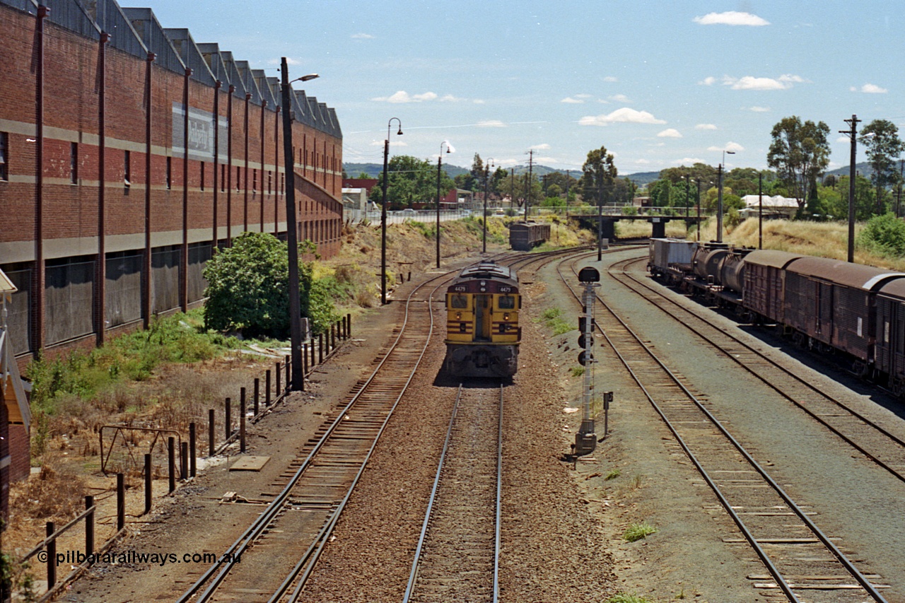 100-14
Albury yard, NSWSRA standard gauge 44 class 4479 AE Goodwin ALCo model DL500B serial G3421-19, readies for Inter-Capital Daylight banker duty, north end of yard looking north, from Wilson Street footbridge, signal post AY61, up shunting neck in the distance LHS, Dalgety's building on the left. [url=https://goo.gl/maps/nngpTA37VQekQpCt7]Geodata[/url].
Keywords: 44-class;4479;AE-Goodwin;ALCo;DL500B;G3421-19;