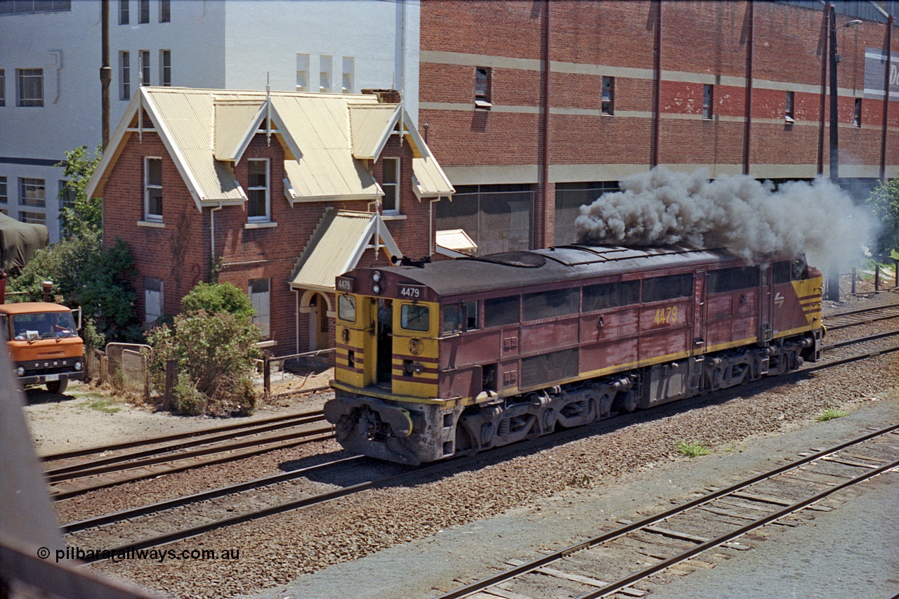 100-16
Albury yard, NSWSRA standard gauge 44 class 4479 AE Goodwin ALCo model DL500B serial G3421-19 smokes up, shunting back onto Inter-Capital Daylight, Dalgety's building behind, from Wilson Street footbridge, gatekeeper's cottage behind the loco. The cottage is a Victorian Neo-Gothic style and was located at 402 Wilson St and built in 1880 by Messrs Batstone and Brewer. Subsequently demolished in 1989. [url=https://goo.gl/maps/nngpTA37VQekQpCt7]Geodata[/url].
Keywords: 44-class;4479;AE-Goodwin;ALCo;DL500B;G3421-19;