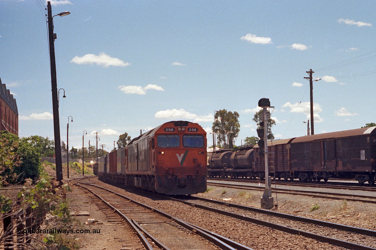 100-17
Albury yard, looking north from Wilson Street, track at left is the up shunting neck, Dalgety's building on the left, V/Line standard gauge G class G 518 Clyde Engineering EMD model JT26C-2SS serial 85-1231 arrives with Melbourne bound goods past signal post AY61. [url=https://goo.gl/maps/GD6wj4qXeCg5BFzr7]Geodata[/url].
Keywords: G-class;G518;Clyde-Engineering-Rosewater-SA;EMD;JT26C-2SS;85-1231;