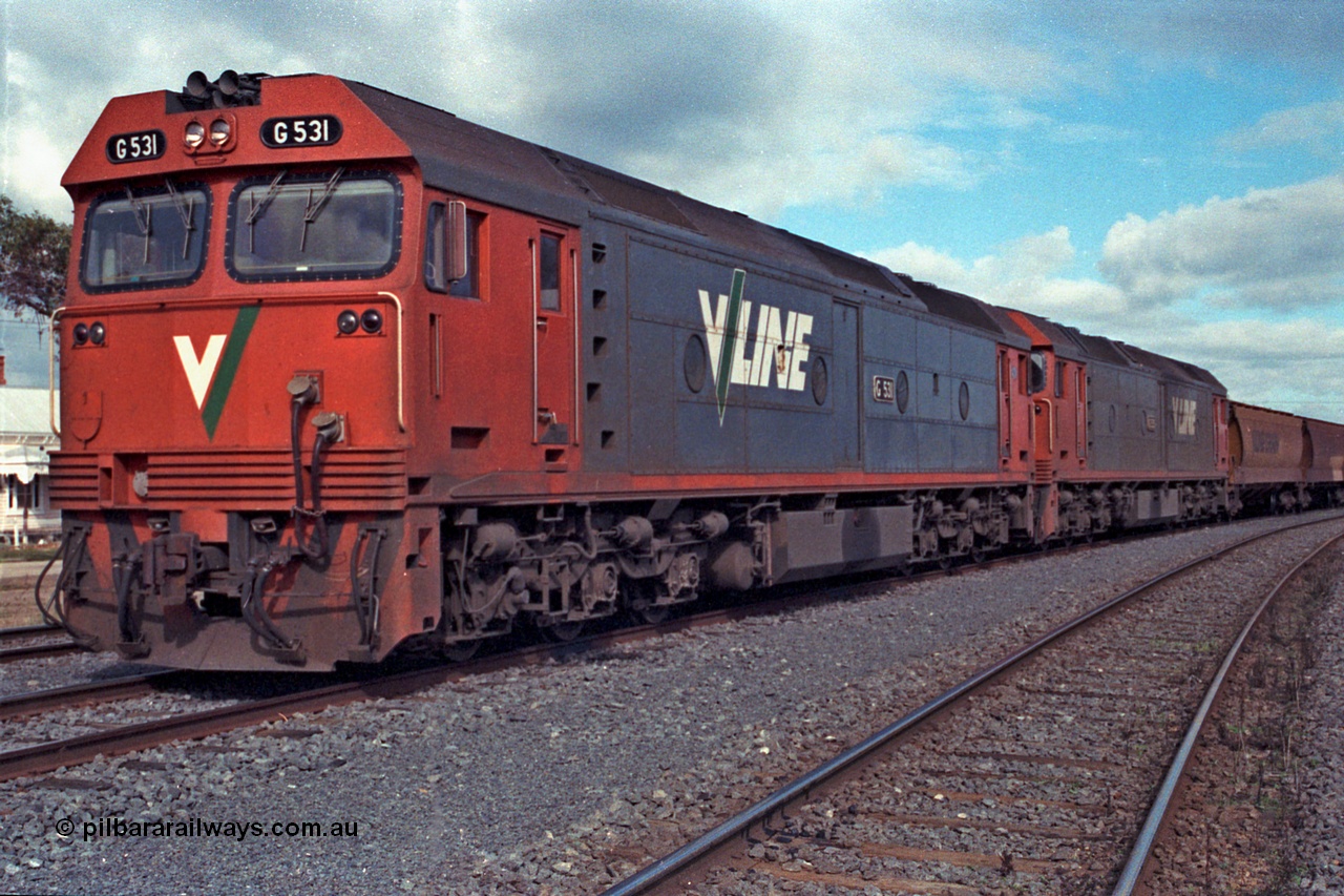 101-08
Maryborough, broad gauge V/Line G class G 531 Clyde Engineering EMD model JT26C-2SS serial 88-1261 and G 535 serial 88-1265, stabled grain train.
Keywords: G-class;G531;Clyde-Engineering-Somerton-Victoria;EMD;JT26C-2SS;88-1261;G535;88-1265;