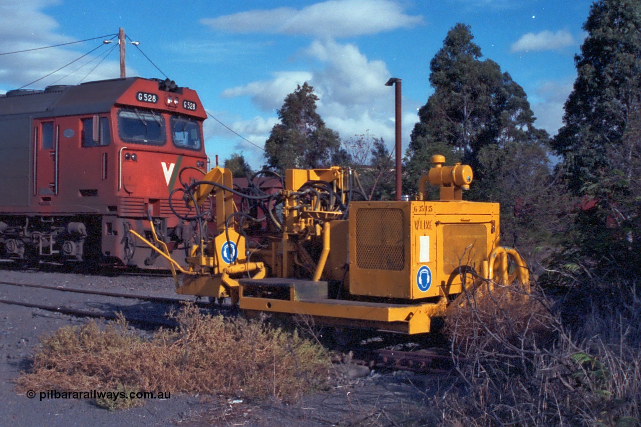 101-24
Donald loco depot, V/line asset number 6-35-135 track machine, possibly spike puller, V/Line G class G 528 Clyde Engineering EMD model JT26C-2SS serial 88-1258.
Keywords: G-class;G528;Clyde-Engineering-Somerton-Victoria;EMD;JT26C-2SS;88-1258;