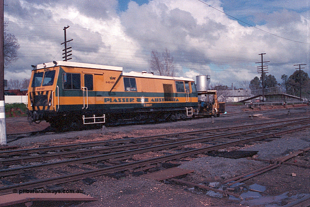 102-24
Wangaratta yard view, V/Line broad gauge track machine 6-62-001, Plasser Flash-butt Welder, model K 355 PT, Melbourne end of yard in fuel siding, standard gauge line behind in cutting, footbridge over it.
Keywords: Plasser;K-355-PT;track-machine;