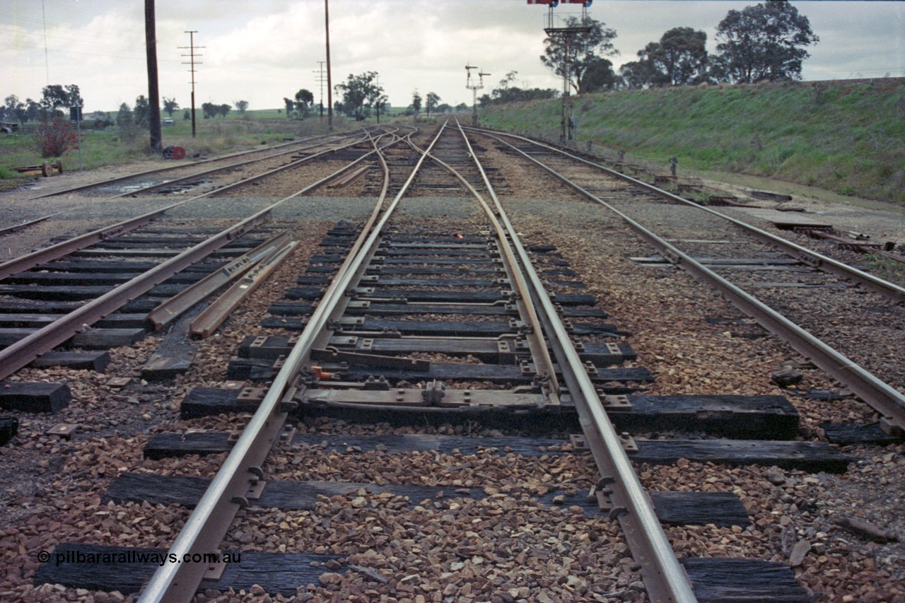 103-10
Springhurst station yard view looking north, mainline points on No.2 Rd for the Wahgunyah line have been spiked and clipped normal, standard gauge flyover on right, yard being rationalised, note redundant disc signal post 5 on ground.
