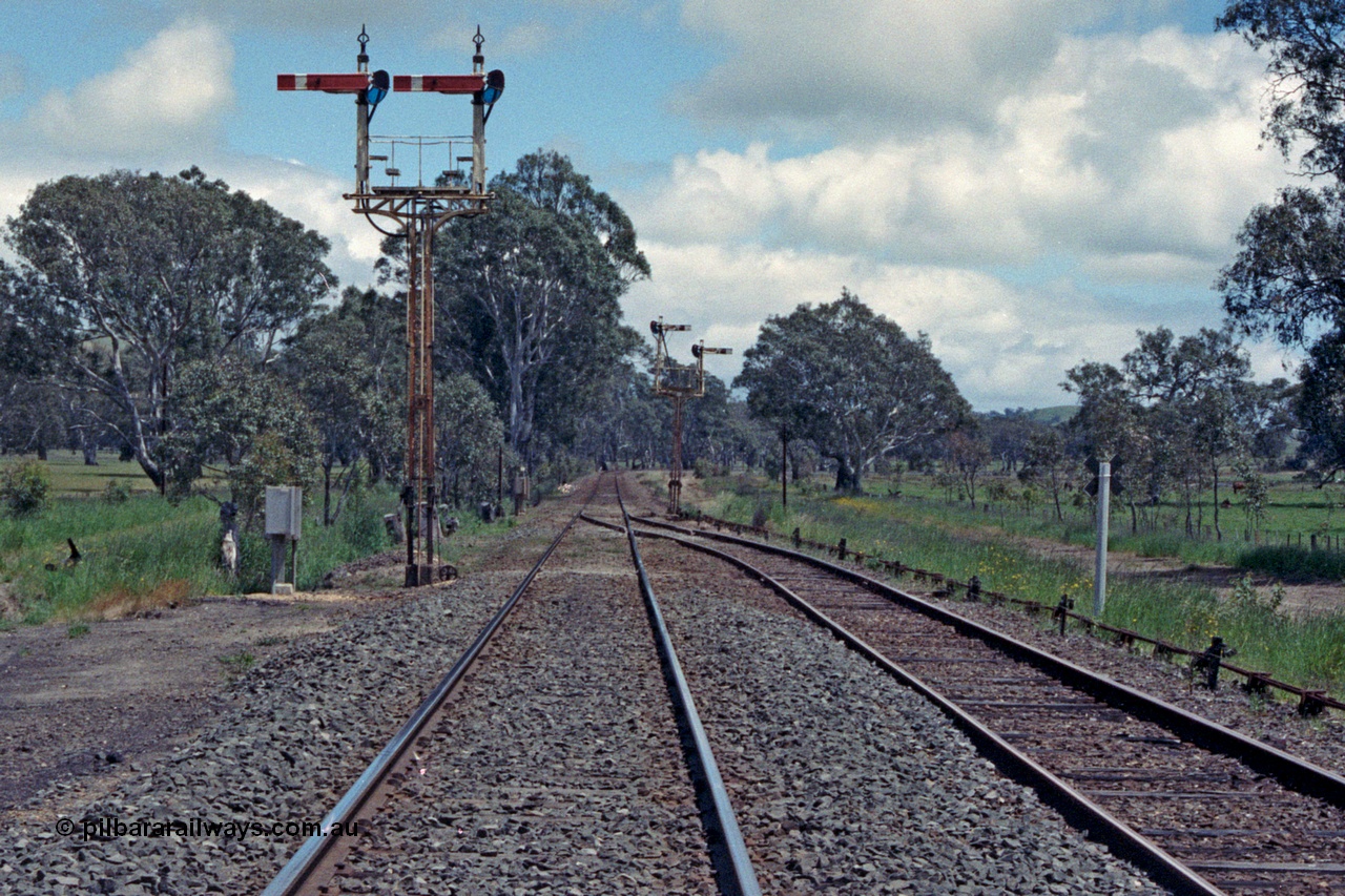 104-05
Buangor crossing loop, yard view looking west, mechanical somersault semaphore signal post 5, Down Home, facing camera and mechanical somersault semaphore signal post 6, Up Home, in the distance facing west, point rodding following No.1 Rd to the points.
