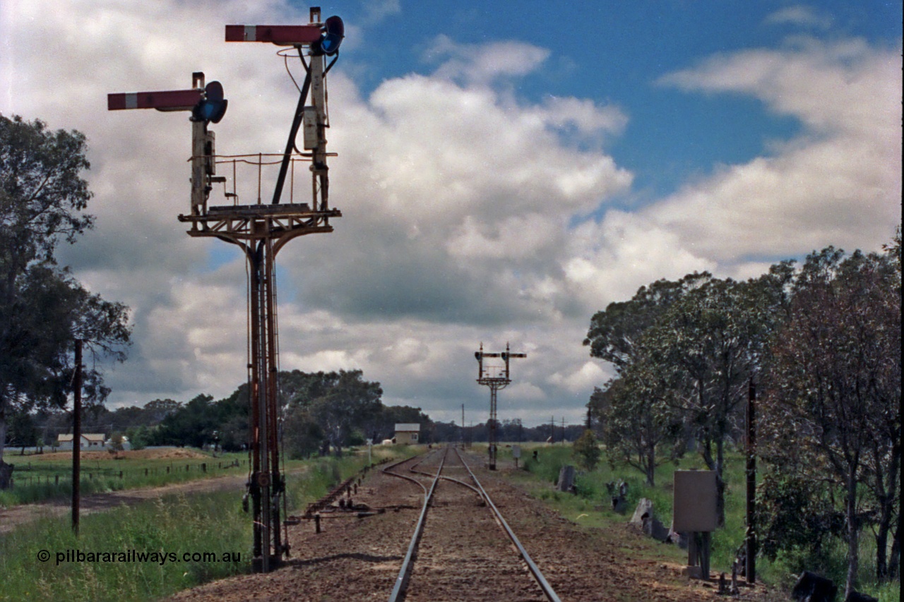 104-06
Buangor crossing loop, yard view looking east, mechanical somersault semaphore signal post 6, Up Home, facing camera for up trains, mechanical somersault semaphore signal post 5, Down Home, in the distance for down trains, point rodding on the left is following No.1 Rd to the points, station building and signal box in the distance.
