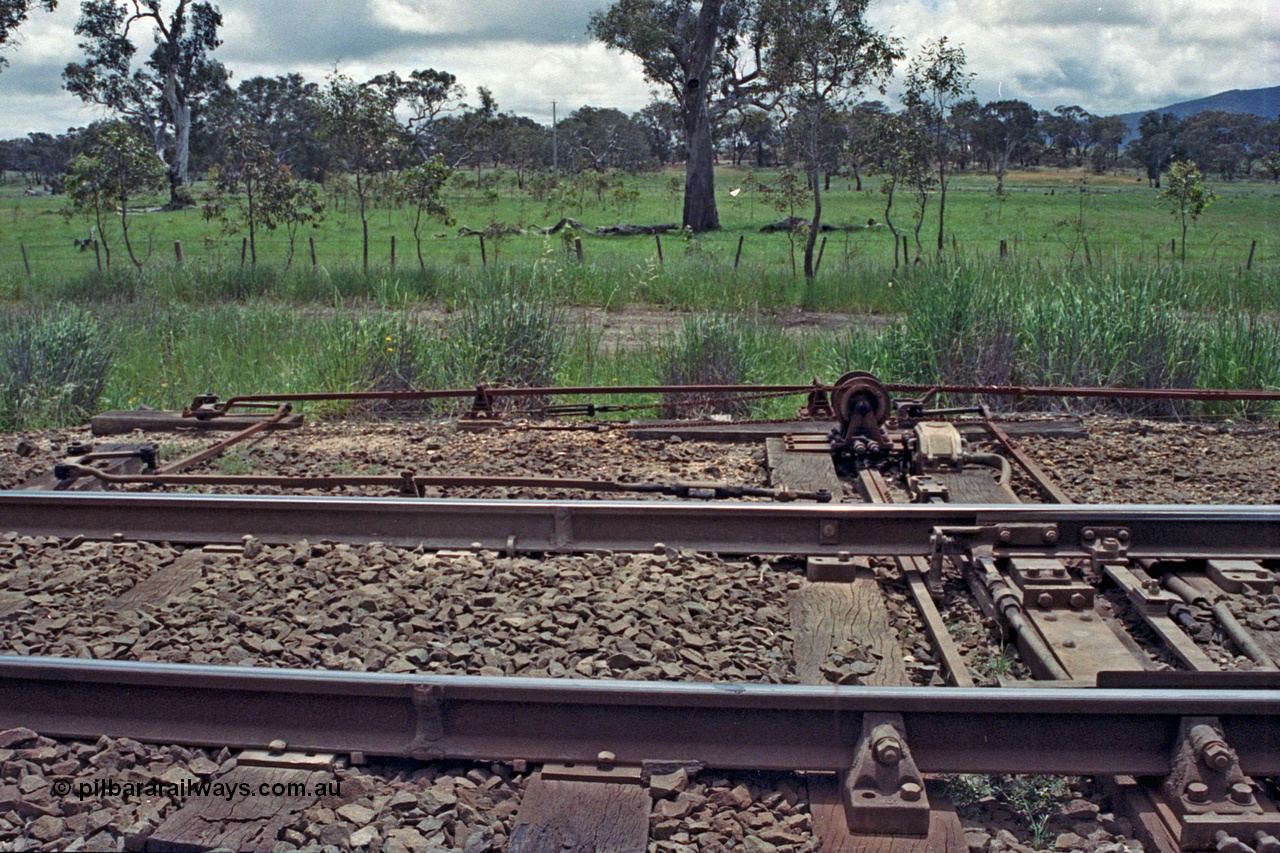 104-08
Buangor crossing loop, detail shot of point blades, rodding and signal wires and the interlocking arrangements at the west end points including plunger, detectors and electric switch lock.
