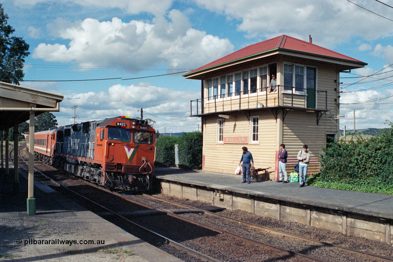 104-20
Wallan station overview looking in a down direction, broad gauge V/Line N class loco N 465 'City of Ballaarat' with serial 86-1194 a Clyde Engineering Somerton Victoria built EMD model JT22HC-2 and N set with an up Albury pass, signaller watches from the elevated signal box built in 1916 with a 40 lever A pattern frame replacing a 20 lever frame on the Down platform.
Keywords: N-class;N465;Clyde-Engineering-Somerton-Victoria;EMD;JT22HC-2;86-1194;