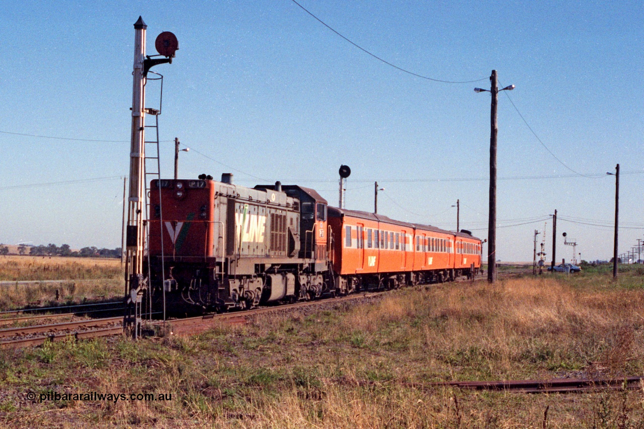 105-02
Wallan, V/Line broad gauge P class P 17 Clyde Engineering EMD model G18HBR serial 84-1216 rebuilt from T 327 Clyde Engineering EMD model G8B serial 56-78 with a Victorian Railways 'Tea Cup' liveried H set with V/Line decals, down passenger train 8319, disc signal post 11 for removed Sidings B, worked out from this shot that on this angle, a P class and H set won't fit between the disc post and light post!!
Keywords: P-class;P17;Clyde-Engineering-Somerton-Victoria;EMD;G18HBR;84-1216;rebuild;