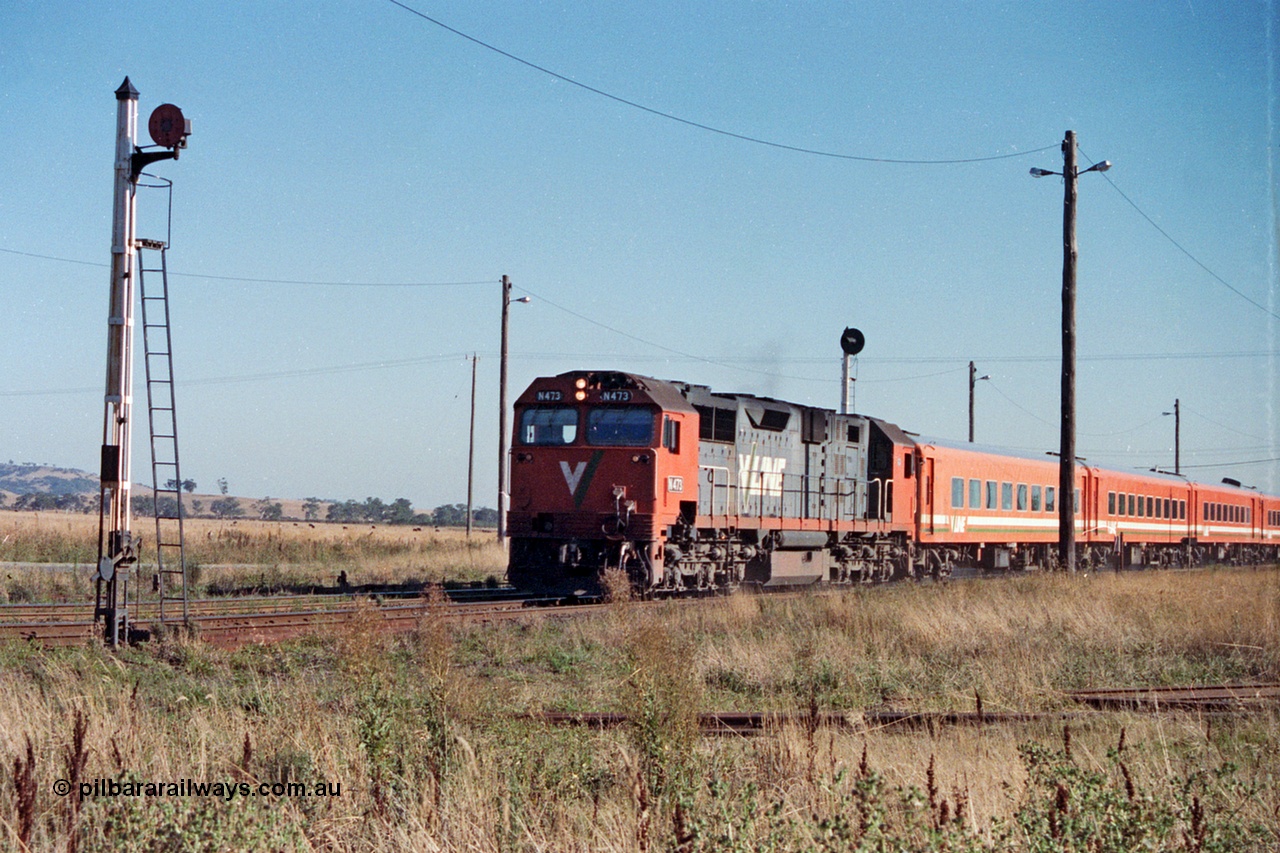 105-03
Wallan, V/Line broad gauge N class N 473 'City of Warragul' Clyde Engineering EMD model JT22HC-2 serial 87-1202 with N set on a down pass, redundant disc signal post 11 at left with searchlight signal post 9 above locomotive.
Keywords: N-class;N473;Clyde-Engineering-Somerton-Victoria;EMD;JT22HC-2;87-1202;