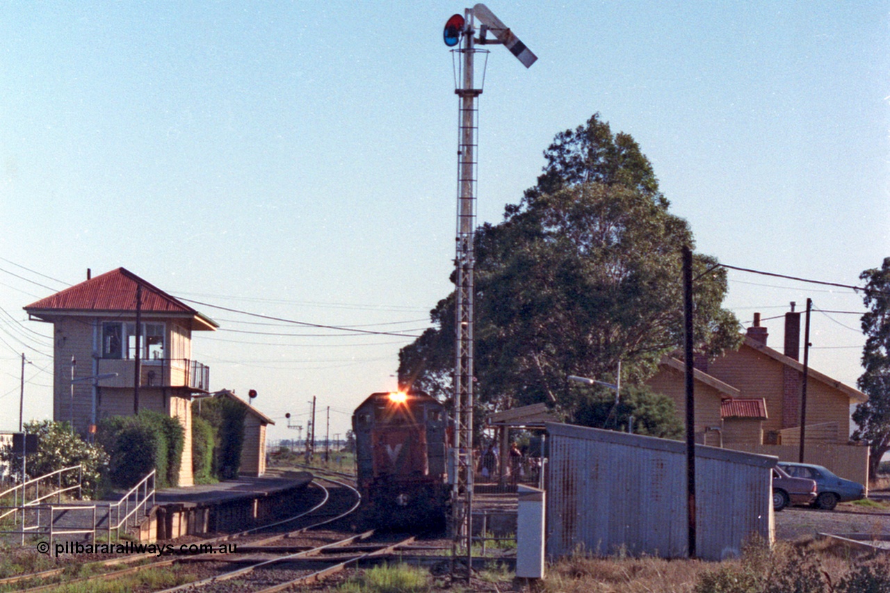 105-04
Wallan, V/Line broad gauge P class P 14 Clyde Engineering EMD model G18HBR serial 84-1208 rebuilt from T 330 Clyde Engineering EMD model G8B serial 56-85 stands at the down platform with passenger train 8323, station building at right, gangers trolley shed and elevated signal box, semaphore signal post 12 pulled off for the move.
Keywords: P-class;P14;Clyde-Engineering-Somerton-Victoria;EMD;G18HBR;84-1208;rebuild;