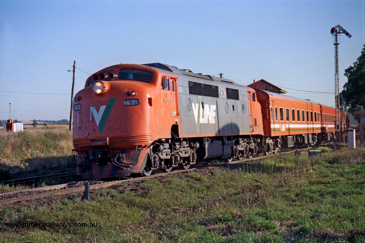 105-07
Wallan, broad gauge named V/Line A class loco A 71 'Dick Reynolds' with serial 83-1180 a Clyde Engineering Rosewater SA rebuild EMD model AAT22C-2R rebuilt from V/Line B class loco B 71 with serial ML2-12 a Clyde Engineering Granville NSW built EMD model ML2 with a Z set work down Cobram passenger train 8327 express through the station past semaphore signal post 12.
Keywords: A-class;A71;Clyde-Engineering-Rosewater-SA;EMD;AAT22C-2R;83-1180;rebuild;bulldog;