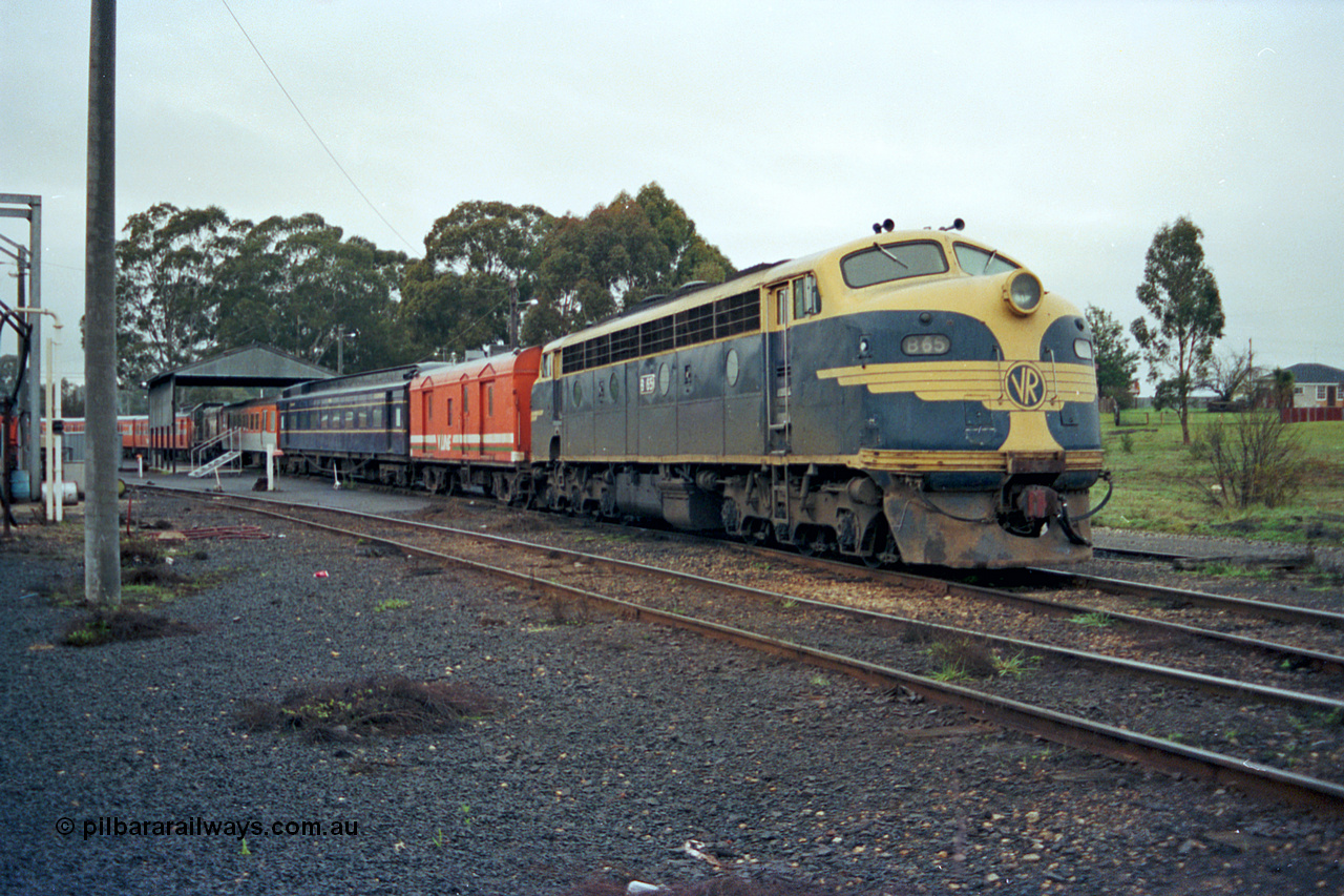 106-17
Seymour broad gauge passenger stabling yard, V/Line B class loco B 65 Clyde Engineering EMD model ML2 serial ML2-6 still in VR or Victorian Railways blue and gold livery with the stabled scratch set, CP class bogie guards van, AE class and MTH class bogie passenger carriages.
Keywords: B-class;B65;Clyde-Engineering-Granville-NSW;EMD;ML2;ML2-6;bulldog;CP-van;AE-class;MTH-class;