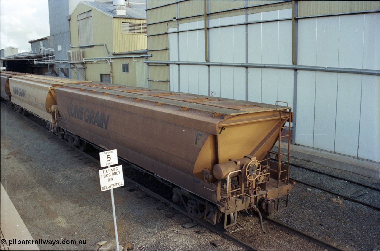 107-25
Echuca yard view, Sidings A, broad gauge V/Line Grain VHGF type bogie grain waggon VHGF 575, hand brake end and roof detail, elevated view, weighbridge road.
Keywords: VHGF-type;VHGF575;