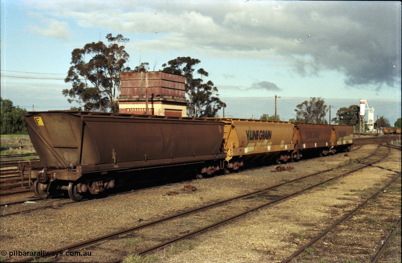 107-28
Echuca station yard, V/Line Grain broad gauge VHGF type bogie grain waggons, No.4 Rd, water tower behind.
Keywords: VHGF-type;