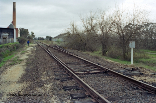 107-03
Kyabram track view, Kyabram Fruit Packers siding points spiked for normal, packing shed on the right, Southern Can Company on the left.
