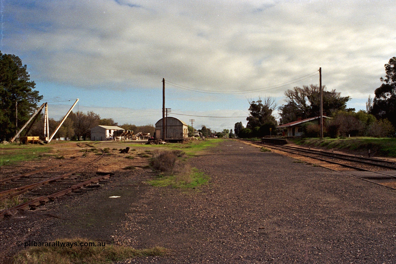 108-21
Tatura station yard overview, derrick crane, super phosphate shed, goods shed and station building, looking north.
