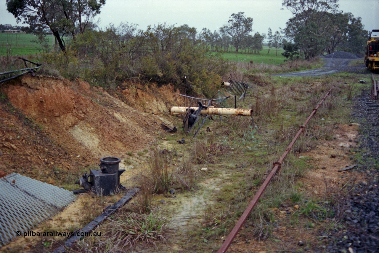 109-09
Broadford Loop, standard gauge, damaged signal bridge remains in drain, point rodding for ballast loading siding and catch points just visible on the right hand edge, looking south
