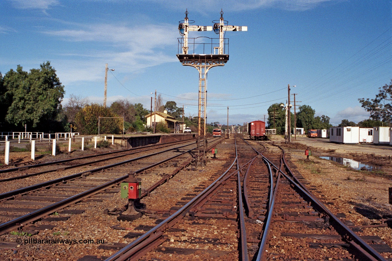 109-20
Avenal station yard overview looking south, prior to rationalisation, semaphore signal post 10 and disc signal post 9 facing away from camera, point indicators and rodding, double compound points, gang camp dongas, Hi-Rail truck on mainline.
