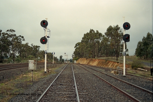 109-07
Broadford Loop, standard gauge, looking north, new searchlight signal posts BRF/6 and BRF/U6 on the right, former signal gantry footings behind posts, not BRF U6 lower target has been trimmed to allow gauge clearance on the ballast loading siding on the right, broad gauge mainline tracks to the left

