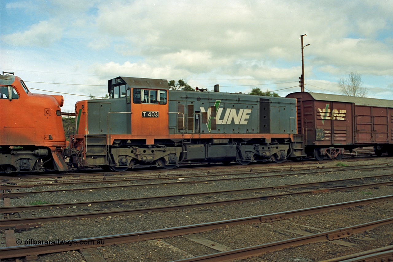 110-05
Benalla yard view, broad gauge V/Line T class loco T 403 with serial 67-498 a Clyde Engineering Granville NSW built EMD model G18B stabled down Wodonga goods train 9303, point rodding, VLCX type bogie louvre van.
Keywords: T-class;T403;Clyde-Engineering-Granville-NSW;EMD;G18B;67-498;