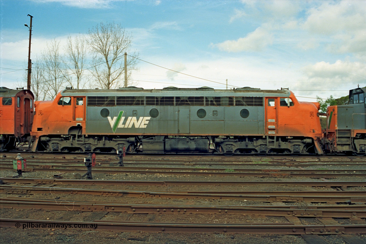 110-06
Benalla yard view, broad gauge V/Line B class B 64 Clyde Engineering EMD model ML2 serial ML2-5, side view, stabled down Wodonga goods train 9303, ground dwarf disc signals, point indicator.
Keywords: B-class;B64;Clyde-Engineering-Granville-NSW;EMD;ML2;ML2-5;bulldog;