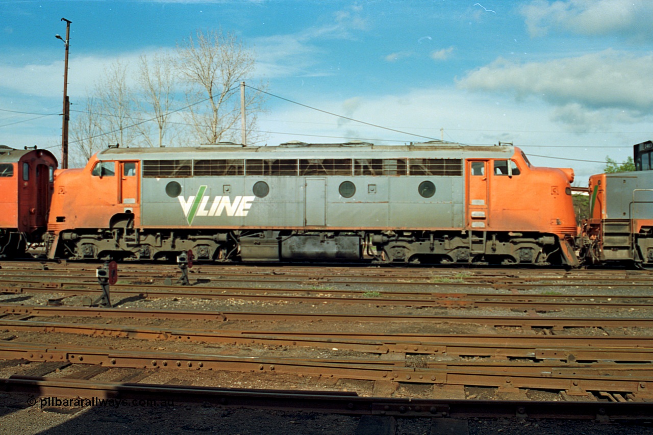 110-10
Benalla yard view, broad gauge V/Line B class B 64 Clyde Engineering EMD model ML2 serial ML2-5, side view, stabled down Wodonga goods train 9303, ground dwarf disc signals.
Keywords: B-class;B64;Clyde-Engineering-Granville-NSW;EMD;ML2;ML2-5;bulldog;