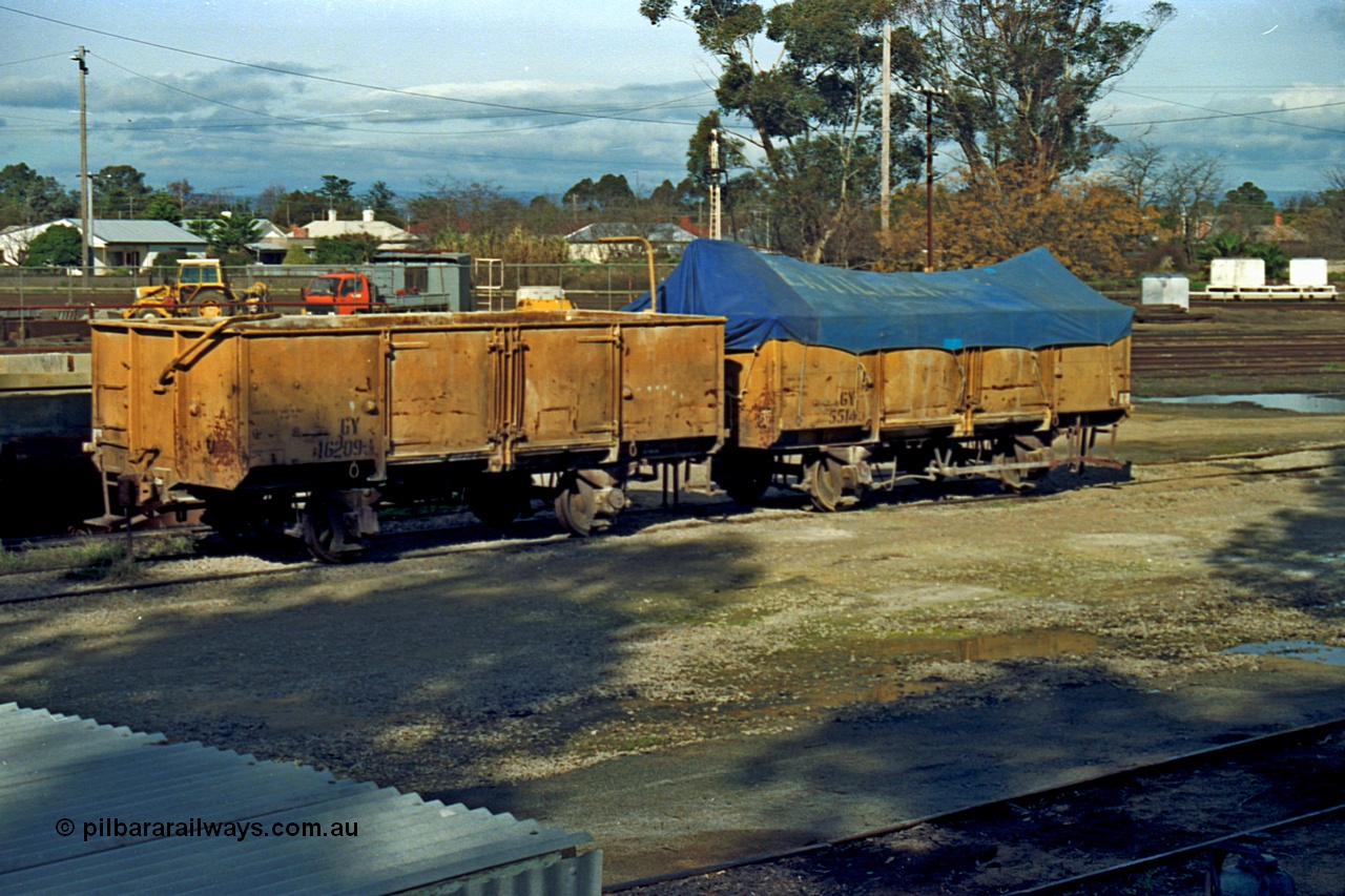 110-14
Benalla yard, GY type four wheel waggons GY 16209 and GY 5514 in super phosphate traffic. GY 5514 built new by AE Goodwin in February 1954, while GY 16209 was built in 1949 by Victorian Railways Newport Workshops as an HY type, in September 1964 recoded to GY.
Keywords: GY-type;GY16209;GY5514;fixed-wheel-waggon;Victorian-Railways-Newport-WS;HY-type;AE-Goodwin;