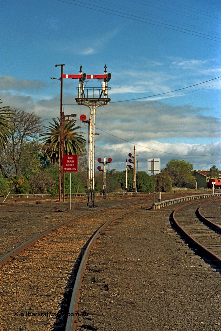 110-15
Benalla, up home semaphore signal post 29B Yarrawonga line into Benalla yard and End of Train Order Working sign, triple disc signal posts 29 and 32 are in the background, taken on the 14th July 1991. Only a couple of weeks later and these signals would be reduced in number greatly as Benalla yard was heavily rationalised, all in the name of progress!
