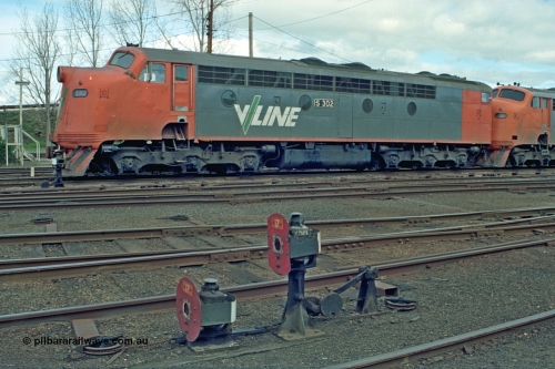 110-02
Benalla yard view, broad gauge V/Line S class S 302 'Edward Henty' Clyde Engineering EMD model A7 serial 57-166, stabled down Wodonga goods train 9303, ground dwarf disc signals 17 and interlocking.
Keywords: S-class;S302;Clyde-Engineering-Granville-NSW;EMD;A7;57-166;bulldog;
