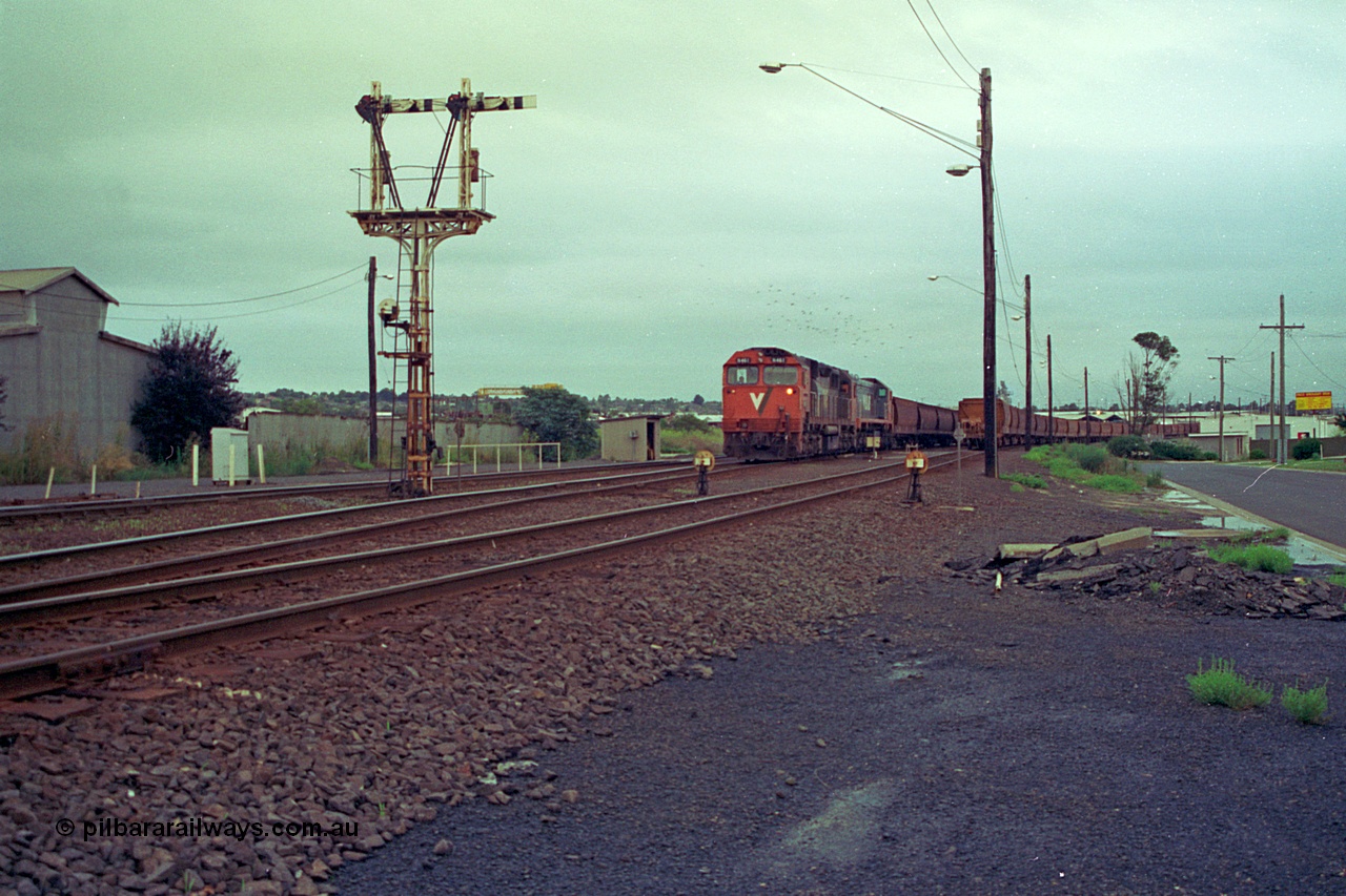 111-01
North Geelong grain arrivals yard, V/Line broad gauge locos N class N 461 'City of Ararat' Clyde Engineering EMD model JT22HC-2 serial 86-1190 and X class X 47 Clyde Engineering EMD model G26C serial 75-794 with a loaded grain rake, semaphore signal post 13 and ground dwarf disc signal 12 and 14 with another loaded grain rake.
Keywords: N-class;N461;Clyde-Engineering-Somerton-Victoria;EMD;JT22HC-2;86-1190;