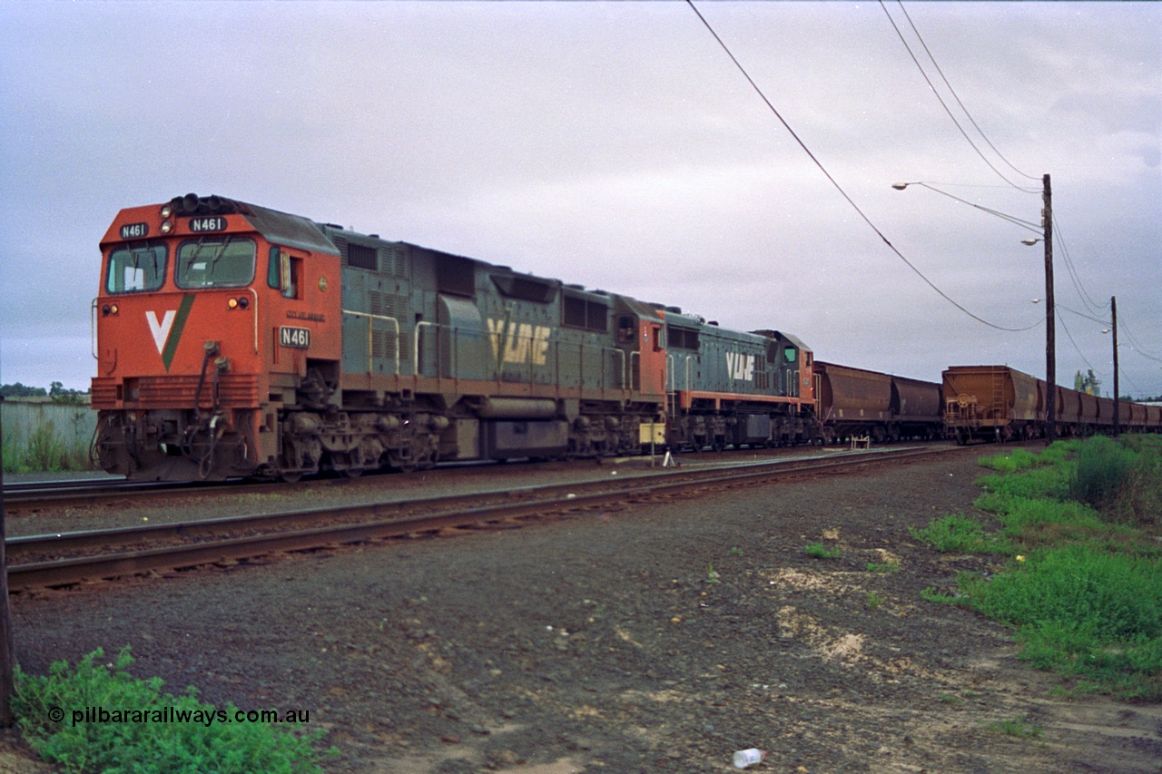 111-02
North Geelong grain arrivals yard, V/Line broad gauge locos N class N 461 'City of Ararat' Clyde Engineering EMD model JT22HC-2 serial 86-1190 and X class X 47 Clyde Engineering EMD model G26C serial 75-794 with a loaded grain rake pump up the air, another loaded grain rake on the right, off focus.
Keywords: N-class;N461;Clyde-Engineering-Somerton-Victoria;EMD;JT22HC-2;86-1190;