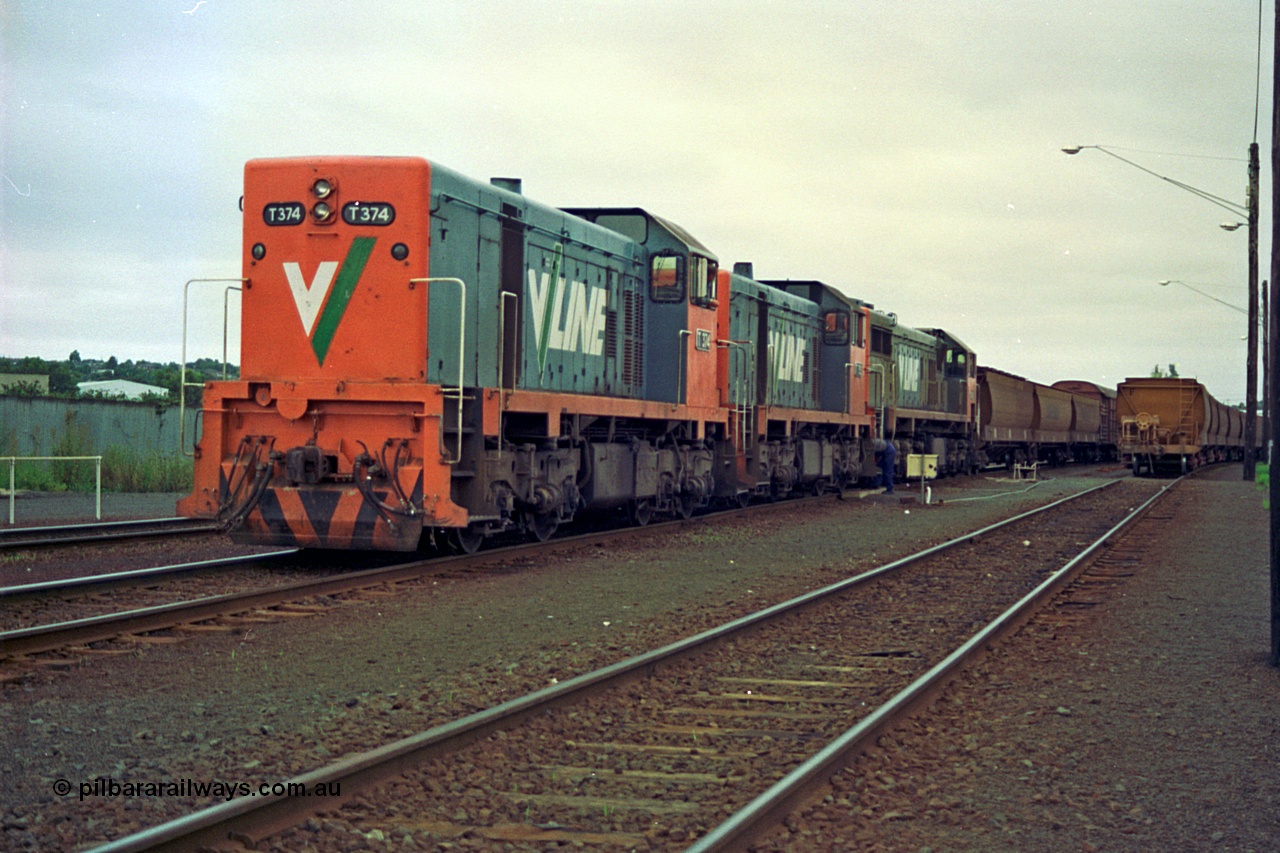 111-06
North Geelong grain arrivals yard, V/Line broad gauge locos T class T 374 Clyde Engineering EMD model G8B serial 64-329, T class 3?? and X class X 42 Clyde Engineering EMD model G26C serial 70-705, up Mt Gambier goods train 9192, 2nd person cutting off the two T class, loaded grain rake on the right.
Keywords: T-class;T374;Clyde-Engineering-Granville-NSW;EMD;G8B;64-329;