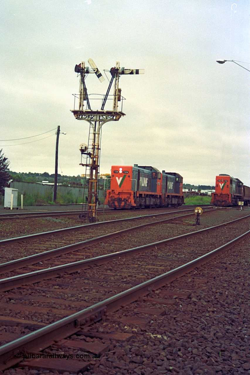 111-10
North Geelong grain arrivals yard, V/Line broad gauge locos T class T 374 Clyde Engineering EMD model G8B serial 64-329 and T class 3?? run back toward North Geelong C Box bound for the loco depot framed between semaphore post 13, ground dwarf disc signal 12 and 9192 up Mt Gambier goods train.
Keywords: T-class;T374;Clyde-Engineering-Granville-NSW;EMD;G8B;64-329;