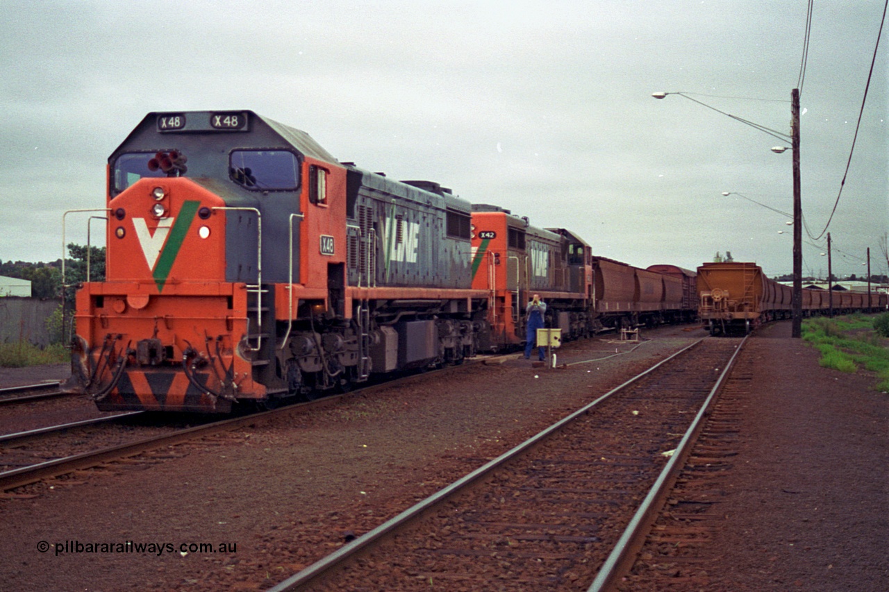 111-11
North Geelong grain arrivals yard, V/Line broad gauge loco X class X 48 Clyde Engineering EMD model G26C serial 75-795 shunts backs onto older sister X 42 serial 70-705 with the up Mt Gambier goods train 9192, loaded grain rake on the right.
Keywords: X-class;X48;Clyde-Engineering-Rosewater-SA;EMD;G26C;75-795;