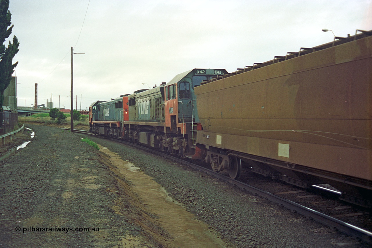 111-13
North Geelong C Box, V/Line broad gauge up Mt Gambier goods train 9192 heads around the Loop Line bound for Melbourne behind X class X 48 Clyde Engineering EMD model G26C serial 75-795 and X 42 serial 70-705, trailing view.
Keywords: X-class;X48;Clyde-Engineering-Rosewater-SA;EMD;G26C;75-795;