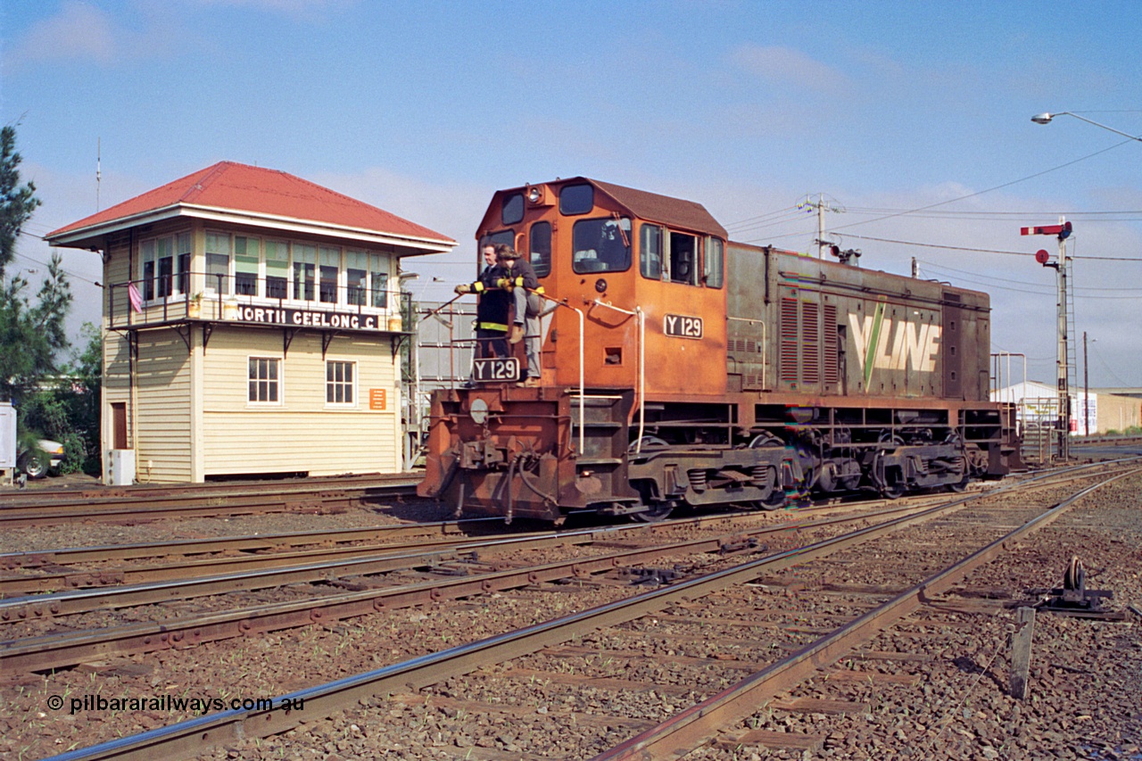 111-19
North Geelong C Box, V/Line broad gauge shunt loco Y class Y 129 Clyde Engineering EMD model G6B serial 65-395 runs back into Geelong Yard light engine from the arrivals, shunters on loco, framed by signal box and signal post 16.
Keywords: Y-class;Y129;Clyde-Engineering-Granville-NSW;EMD;G6B;65-395;