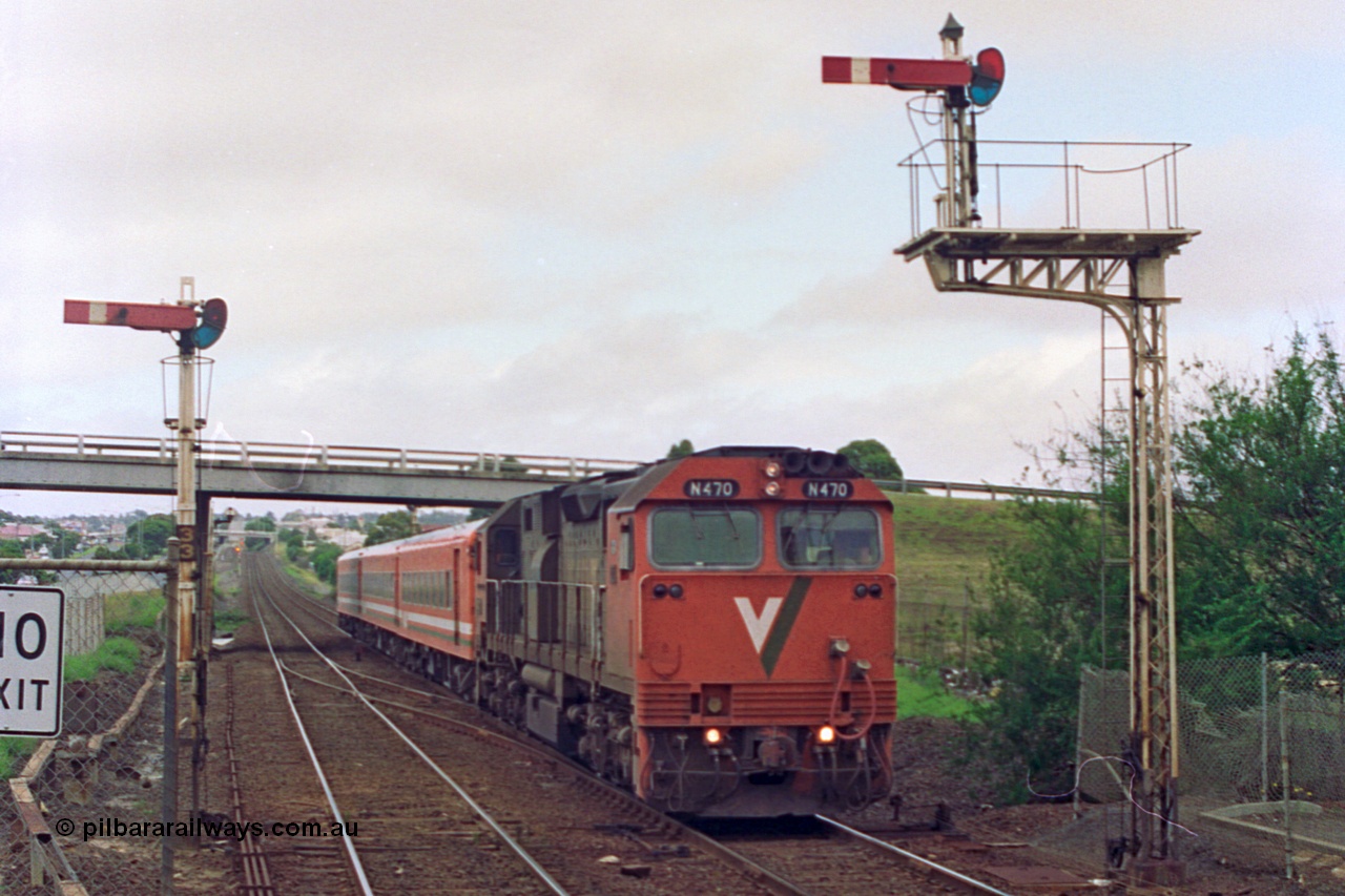 111-24
North Geelong station, V/Line broad gauge N class N 470 'City of Wangaratta' Clyde Engineering EMD model JT22HC-2 serial 86-1199 and N set work an up Geelong passenger train to Melbourne as it splits semaphore signal posts 33 and 34, driver only operation.
Keywords: N-class;N470;Clyde-Engineering-Somerton-Victoria;EMD;JT22HC-2;86-1199;