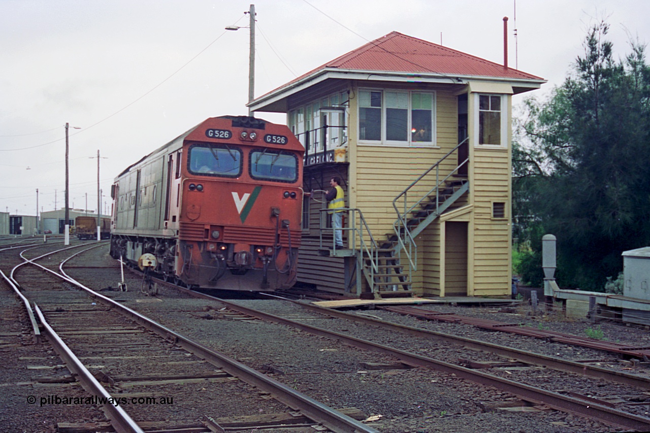 111-27
North Geelong C Box, V/Line broad gauge light loco G class G 526 Clyde Engineering EMD model JT26C-2SS serial 88-1256 surrenders the electric staff for to the Nth Geelong signaller for the section Nth Geelong B to Nth Geelong C, catch points, ground disc signal, point rodding, safeworking.
Keywords: G-class;G526;Clyde-Engineering-Somerton-Victoria;EMD;JT26C-2SS;88-1256;