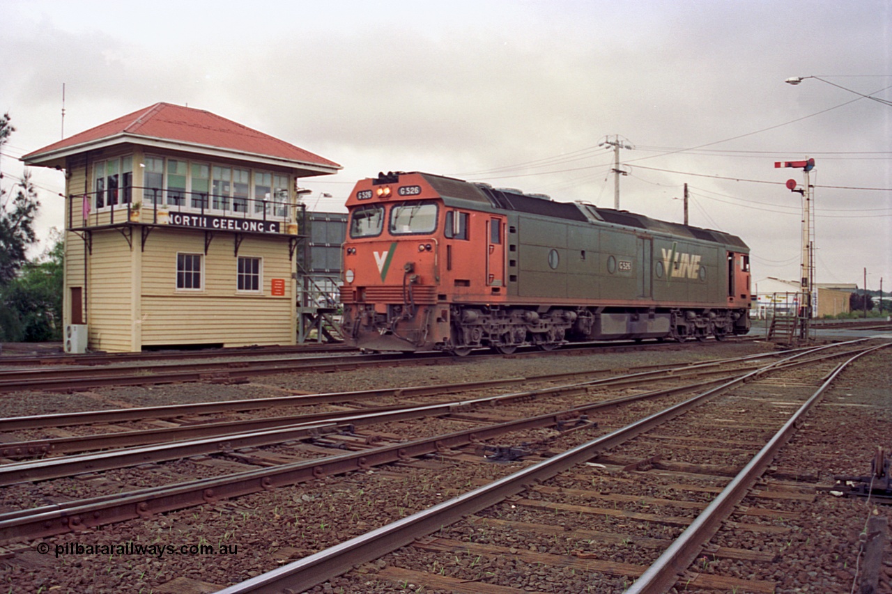 111-28
North Geelong C Box, V/Line broad gauge light loco G class G 526 Clyde Engineering EMD model JT26C-2SS serial 88-1256 shunts back into North Geelong Yard for an empty grain train rake, framed between the signal box and semaphore signal post 16.
Keywords: G-class;G526;Clyde-Engineering-Somerton-Victoria;EMD;JT26C-2SS;88-1256;