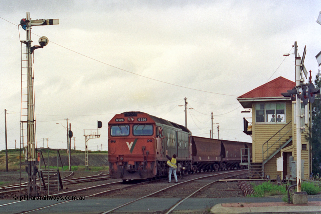 111-30
North Geelong C Box, V/Line broad gauge down grain train 9121 departs the yard behind G class G 526 Clyde Engineering EMD model JT26C-2SS serial 88-1256 as the driver obtains the electric staff for the section to Gheringhap, semaphore signal post 16, level crossing and point rodding.
Keywords: G-class;G526;Clyde-Engineering-Somerton-Victoria;EMD;JT26C-2SS;88-1256;