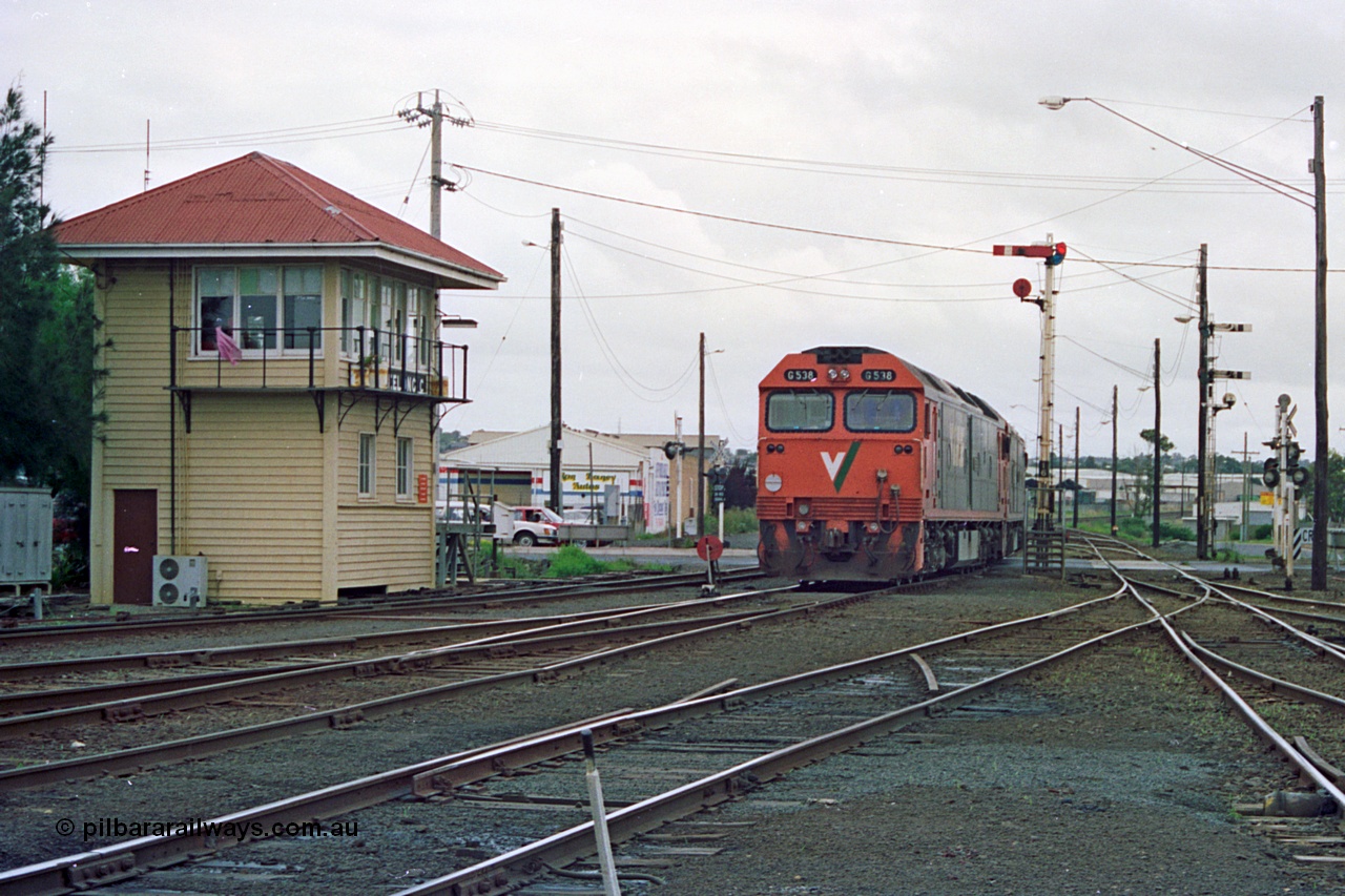 111-35
North Geelong C Box, V/Line broad gauge light engines Series 1 G class leader G 511 Clyde Engineering EMD model JT26C-2SS serial 84-1239 and G 538 Clyde Engineering EMD model JT26C-2SS serial 89-1271 shunt back into the yard past C box and splitting ground dwarf signal 18 and semaphore signal post 16, track view of levers and points, catch points, signal box and posts, destined for empty grain train 9123.
Keywords: G-class;G538;Clyde-Engineering-Somerton-Victoria;EMD;JT26C-2SS;89-1271;