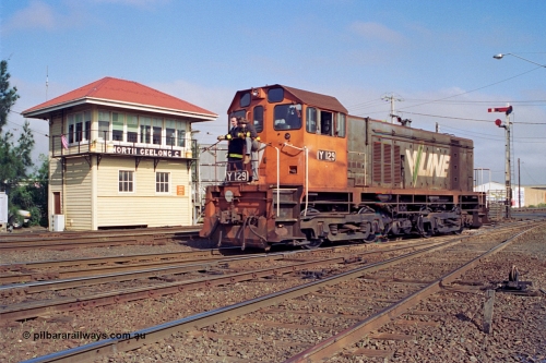 111-19
North Geelong C Box, V/Line broad gauge shunt loco Y class Y 129 Clyde Engineering EMD model G6B serial 65-395 runs back into Geelong Yard light engine from the arrivals, shunters on loco, framed by signal box and signal post 16.
Keywords: Y-class;Y129;Clyde-Engineering-Granville-NSW;EMD;G6B;65-395;