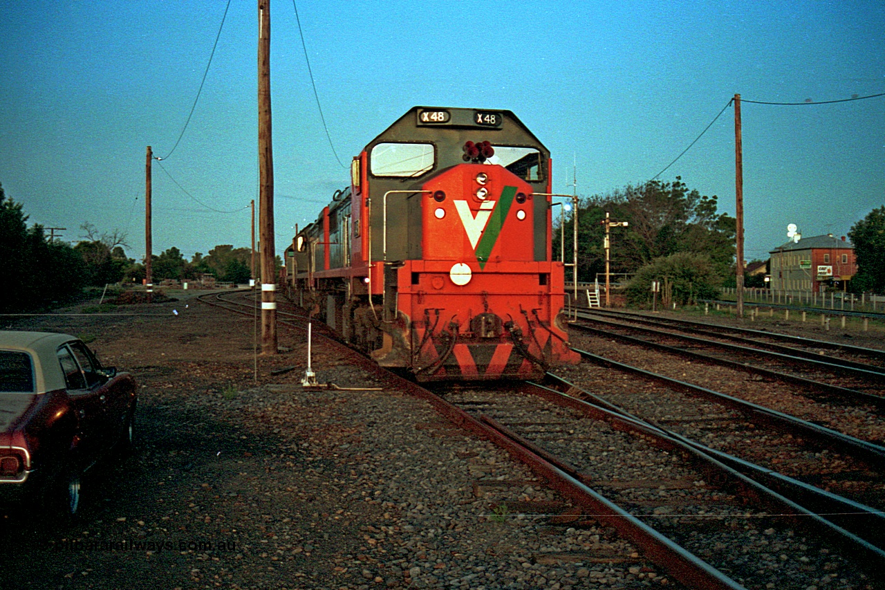 112-12
Benalla yard, broad gauge V/Line X class X 48 Clyde Engineering EMD model G26C serial 75-795 and two other X class with the Sunday up slab steel train 9334, having their crib break and to allow the evening passenger trains to run past prior to continuing to Long Island later in the evening, night shot, March 1994.
Keywords: X-class;X48;Clyde-Engineering-Rosewater-SA;EMD;G26C;75-795;