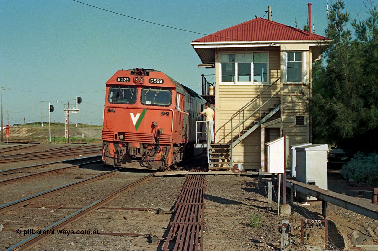 112-35
North Geelong C Box, V/Line broad gauge light engines G class G 529 Clyde Engineering EMD model JT26C-2SS serial 88-1259 and sister have just surrendered the electric staff for Nth Geelong B to Nth Geelong C section to the signaller at C Box signal man, safeworking, point rodding, staff exchange, track view, signal box.
Keywords: G-class;G529;Clyde-Engineering-Somerton-Victoria;EMD;JT26C-2SS;88-1259;