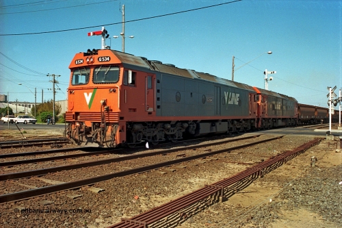 112-18
North Geelong C Box, V/Line broad gauge G class G 534 Clyde Engineering EMD model JT26C-2SS serial 88-1264 leads sister G class across Separation Street with an empty grain train departing, point rodding in foreground.
Keywords: G-class;G534;Clyde-Engineering-Somerton-Victoria;EMD;JT26C-2SS;88-1264;