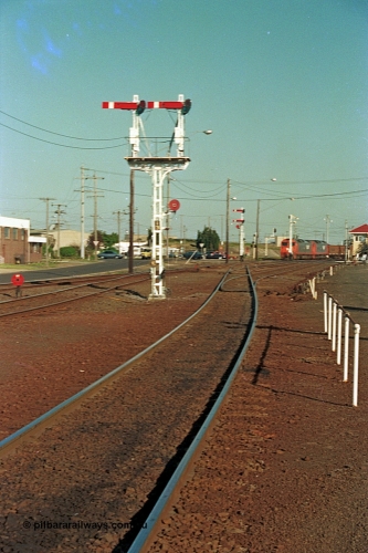 112-37
North Geelong C Box, looking east, semaphore signal post 13 freshly repainted, standing on broad gauge mainline to Gheringhap, grain arrivals at left, in the distance V/Line G class G 529 Clyde Engineering EMD model JT26C-2SS serial 88-1259 leads a departing grain train, off focus.
Keywords: G-class;G529;Clyde-Engineering-Somerton-Victoria;EMD;JT26C-2SS;88-1259;