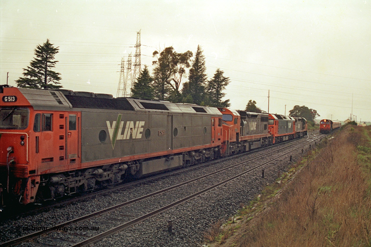 113-08
Warrenheip, V/Line broad gauge up Adelaide goods train 9150 behind the quad CGCG combo of C class C 506 Clyde Engineering EMD model GT26C serial 76-829, G class G 538 Clyde Engineering EMD model JT26C-2SS serial 89-1271, C class C 510 serial 76-833 and G class G 513 serial 85-1241, in miserable conditions, wait as a down passenger train with N class N 472 'City of Sale' Clyde Engineering EMD model JT22HC-2 serial 87-1201 and double N set passes.
Keywords: G-class;G513;Clyde-Engineering-Rosewater-SA;EMD;JT26C-2SS;85-1241;