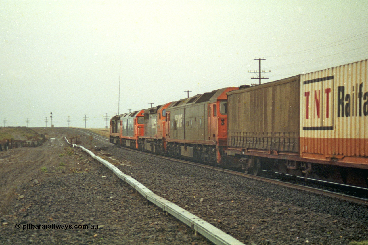 113-16
Bank Box Loop, V/Line broad gauge up Adelaide goods train 9150 behind the quad CGCG combo of C class C 506 Clyde Engineering EMD model GT26C serial 76-829, G class G 538 Clyde Engineering EMD model JT26C-2SS serial 89-1271, C 510 serial 76-833 and G 513 serial 85-1241, in miserable conditions, poor quality, trailing view.
